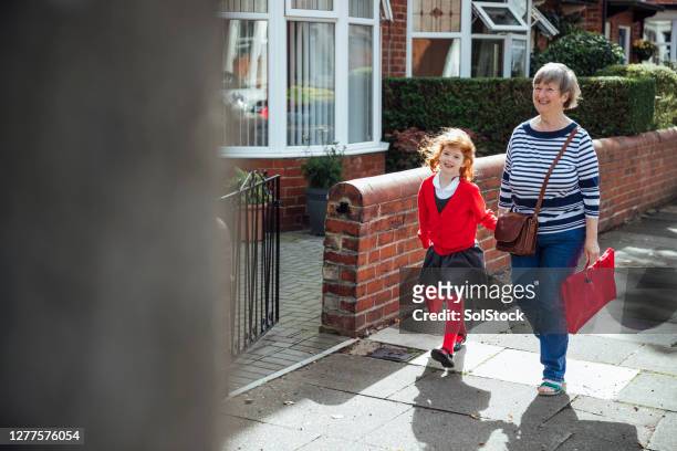 walking with grandma - british culture walking stock pictures, royalty-free photos & images