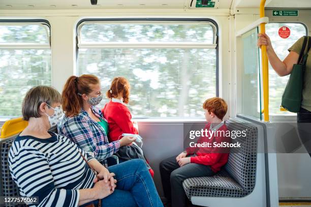 masks on public transport - train interior stock pictures, royalty-free photos & images