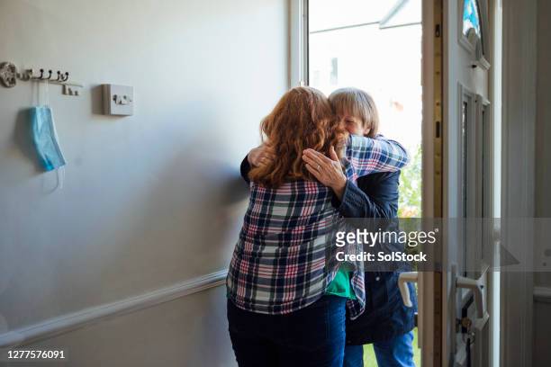 hugging my mother again - mother and daughter hugging stock pictures, royalty-free photos & images