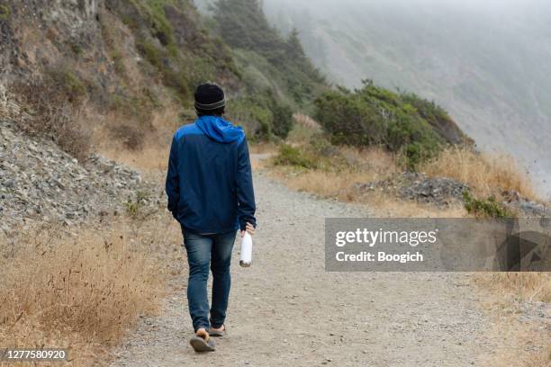 el hombre caucásico camina por la costa hasta enderts beach en california, ee. uu. en el frío día de verano - redwood shores fotografías e imágenes de stock