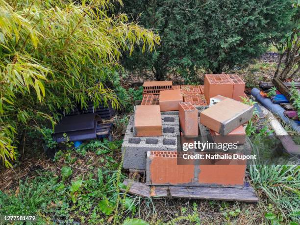 pile of old building bricks in an outdoor garden - dismantling stock pictures, royalty-free photos & images