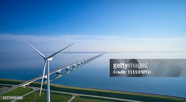 zeeland bridge aerial with wind turbine - netherlands stock pictures, royalty-free photos & images