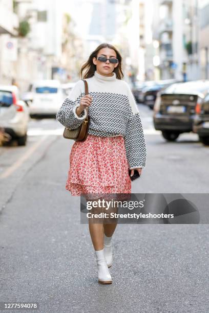 Influencer Sarah Lou Falk, wearing a white pullover with black pattern by Lala Berlin, a red dress with floral pattern by Mads Noorgard, white...