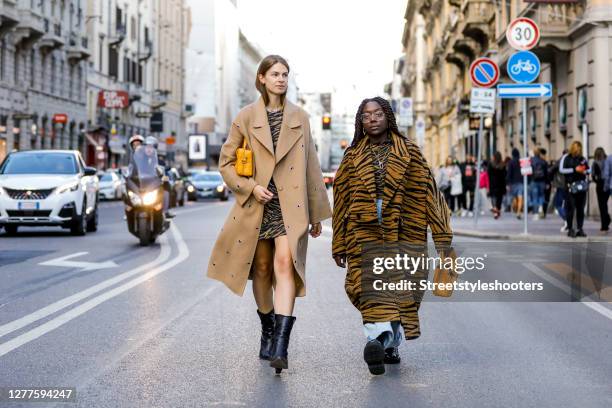 Influencer Jacqueline Zelwis, wearing a beige coat by Lala Berlin, an animal printed dress by Lala Berlin, black boots by Fendi and a dark yellow bag...