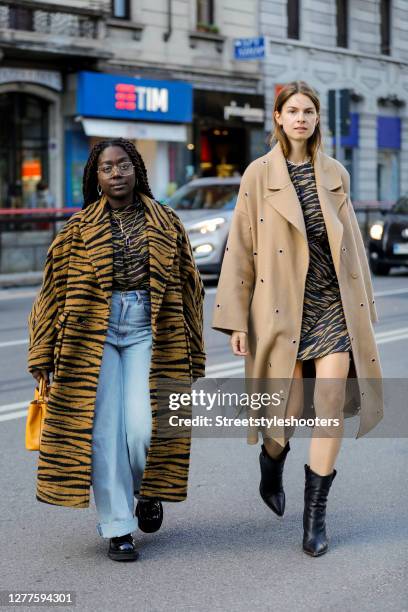 Influencer Lois Opoku, wearing a tiger colored coat with tiger pattern by Lala Berlin, a tiger colored shirt with tiger pattern by Lala Berlin, a...