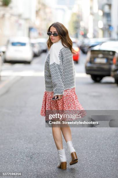 Influencer Sarah Lou Falk, wearing a white pullover with black pattern by Lala Berlin, a red dress with floral pattern by Mads Noorgard, white...