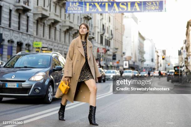 Influencer Jacqueline Zelwis, wearing a beige coat by Lala Berlin, an animal printed dress by Lala Berlin, black boots by Fendi and a dark yellow bag...