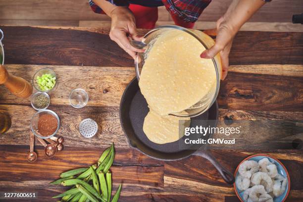 preparing iron cast skillet corn bread - corn bread stock pictures, royalty-free photos & images