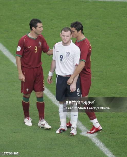 World Cup Football Quarter Final. England v Portugal."nCristiano Ronaldo whispers in the ear of Wayne Rooney before the match begins."n."n