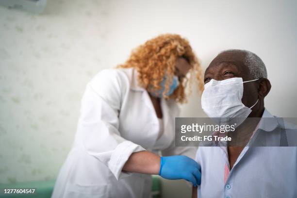 nurse applying vaccine on patient's arm - old laboratory stock pictures, royalty-free photos & images
