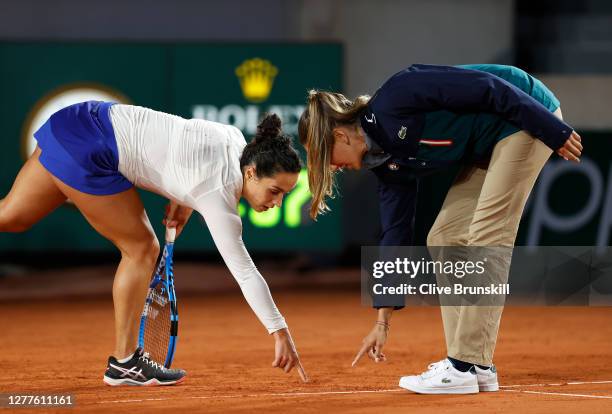 Martina Trevisan of Italy challenges a line call with the chair umpire during her Women's Singles second round match against Cori Gauff of The United...