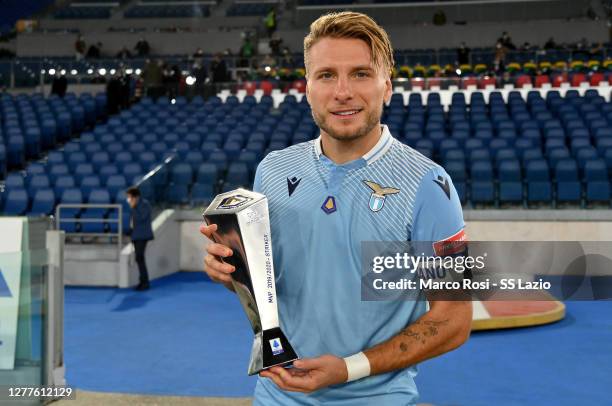 Ciro Immobile of SS Lazio player poses with the MVP best strike award during the Serie A match between SS Lazio and Atalanta BC at Stadio Olimpico on...