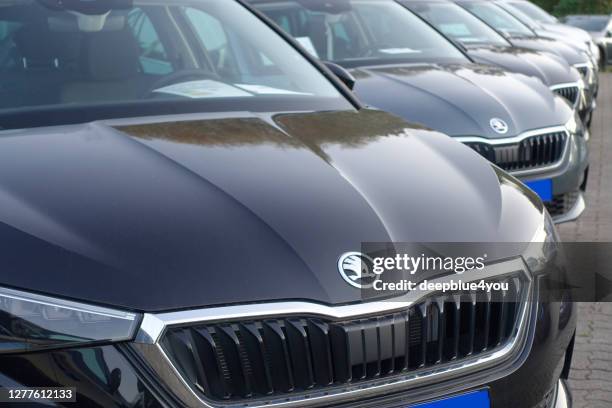 a row of used skoda cars parked at a public car dealership in hamburg, germany - skoda auto stock pictures, royalty-free photos & images