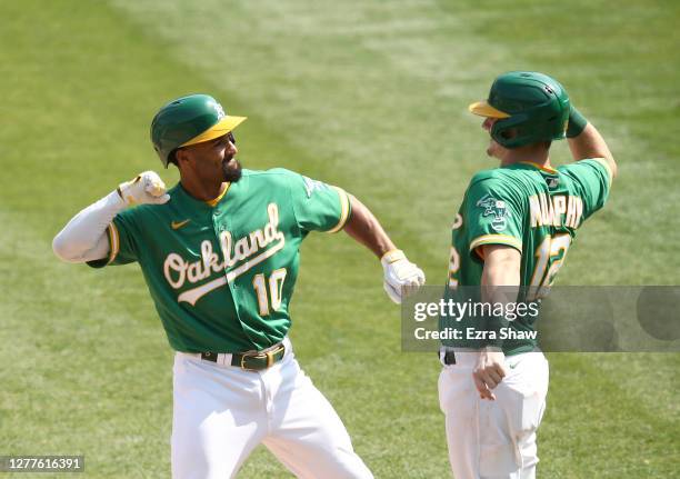 Marcus Semien of the Oakland Athletics is congratulated by Sean Murphy after he hit a two-run home run against the Chicago White Sox in the second...