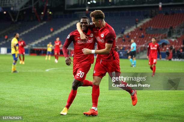 Patson Daka of RB Salzburg celebrates with teammate Mergim Berisha after scoring his sides third goal during the UEFA Champions League Play-Off...