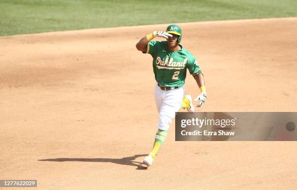 Khris Davis of the Oakland Athletics salutes the dugout as he rounds the bases after hitting a home run against the Chicago White Sox in the fourth...