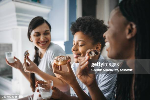 the family enjoys the donuts - friends donut stock pictures, royalty-free photos & images