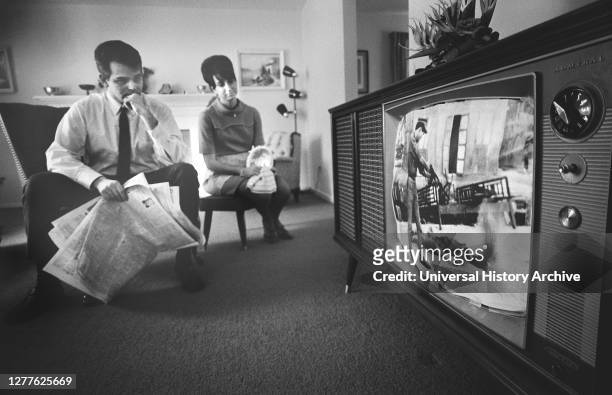 Man and Woman watching Film Footage of Vietnam war on Television in their Living Room, Warren K. Leffler, February 13, 1968.
