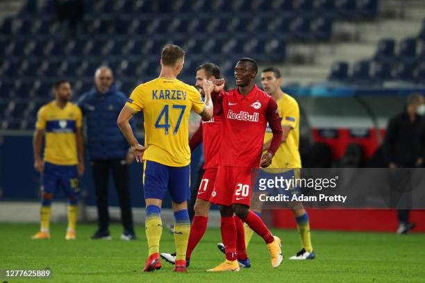 Patson Daka of RB Salzburg fist bumps with Eden Karzev of Maccabi Tel-Aviv following the UEFA Champions League Play-Off second leg match between RB...