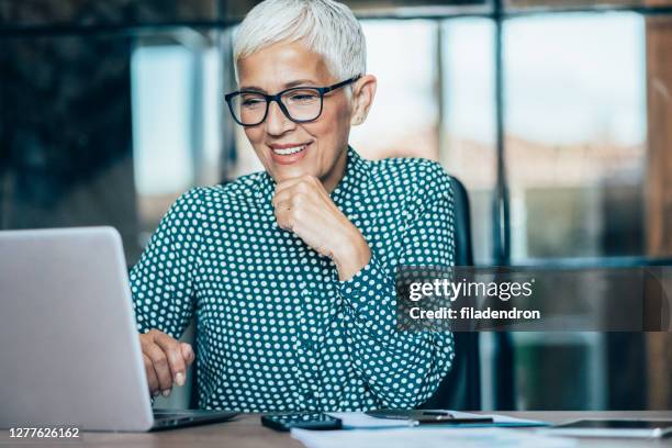 business woman working - senior adult on computer stock pictures, royalty-free photos & images