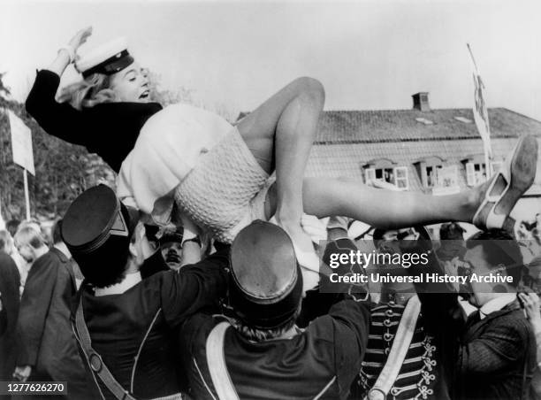 Actress Pia Degermark being lifted in the air during Graduation Ceremonies at the Exclusive Sigtunaskolan, Sweden, UPI, June 12, 1968.