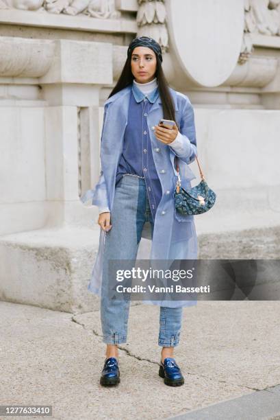 Guest poses with a Louis Vuitton bag after the Acne Studios show at the Grand Palais during Paris Fashion Week - Womenswear Spring summer 2021 on...