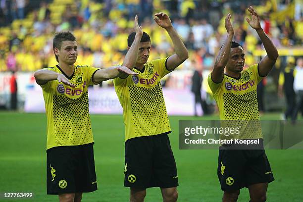 Lukasz Piszczek, Robert Lewandowski and Antonio da Silva of Dortmund celebrate the 4-0 victory after the Bundesliga match between Borussia Dortmund...
