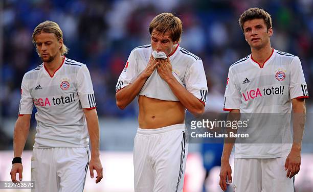 Anatoliy Tymoshchuk, Holger Badstuber and Thomas Mueller of Muenchen are looking dejected after the Bundesliga match between 1899 Hoffenheim and FC...