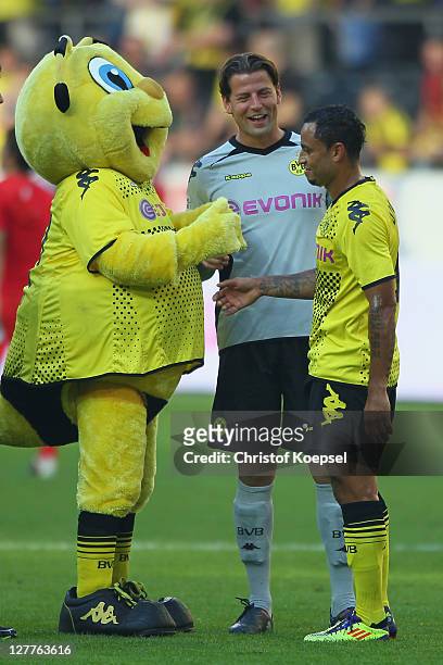 Mascot Emma, Roman Weidenfeller and Antonio da Silva of Dortmund celebrate the 4-0 victory after the Bundesliga match between Borussia Dortmund and...