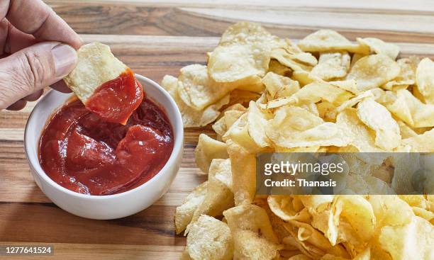 potato chips with ketchup - mojar fotografías e imágenes de stock