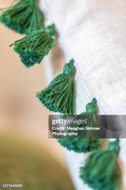 tassels on a linen cushion - wonky fringe stock pictures, royalty-free photos & images