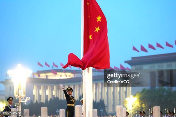 Soldiers of the People's Liberation Army honor guard perform the flag-raising ceremony at Tiananmen Square to mark the 71st Anniversary of the...