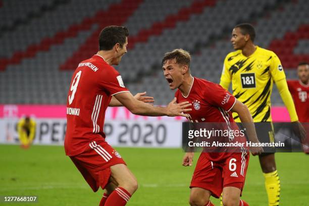 Joshua Kimmich of FC Bayern Muenchen celebrates scoring the winning goal with his team mate Robert Lewandowski during the Supercup 2020 match between...