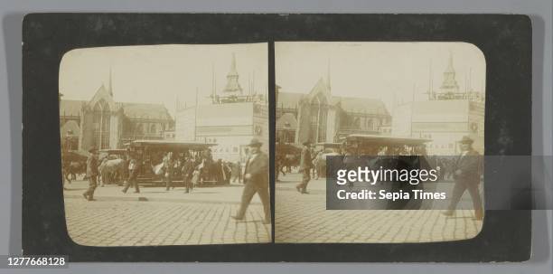 Passers-by and horse-drawn trams on Dam Square with the image 'De Eendracht', better known as 'Naatje van de Dam' , Amsterdam, the Netherlands,...