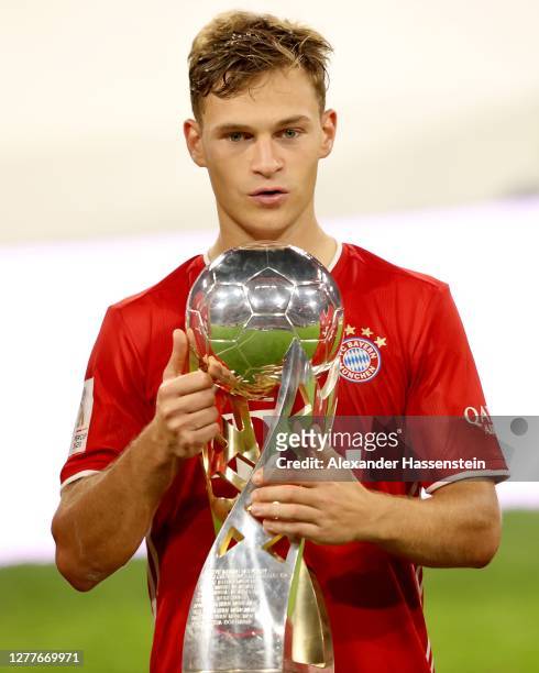 Joshua Kimmich of FC Bayern Muenchen celebrates with the Supercup trophy after the Supercup 2020 match between FC Bayern München and Borussia...