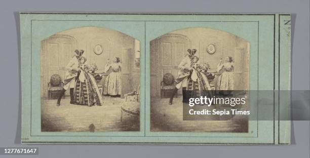 Theatrical representation of a woman who enters a room where a couple of lovers in historical costumes are standing in an embrace, couple of lovers,...