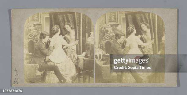 Man ties a woman's corset in front of a mirror, mirror, lacing up a corset, Europe, anonymous, c. 1850 - c. 1880, cardboard, photographic paper,...