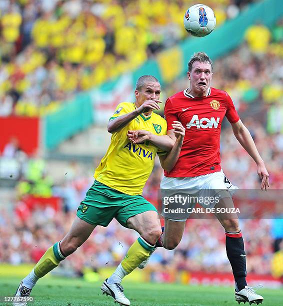 Manchester United's English defender Phil Jones vies with Norwich City's Welsh striker Steve Morison during the English Premier League football match...