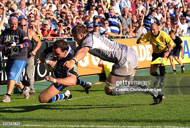 Matt Carraro of Bath scores a try as Ed Slater of Tigers tries to stop him during the AVIVA Premiership match between Bath and Leicester Tigers at...