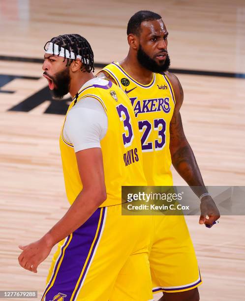 Anthony Davis of the Los Angeles Lakers and LeBron James of the Los Angeles Lakers react to his rebound and basket during the third quarter against...