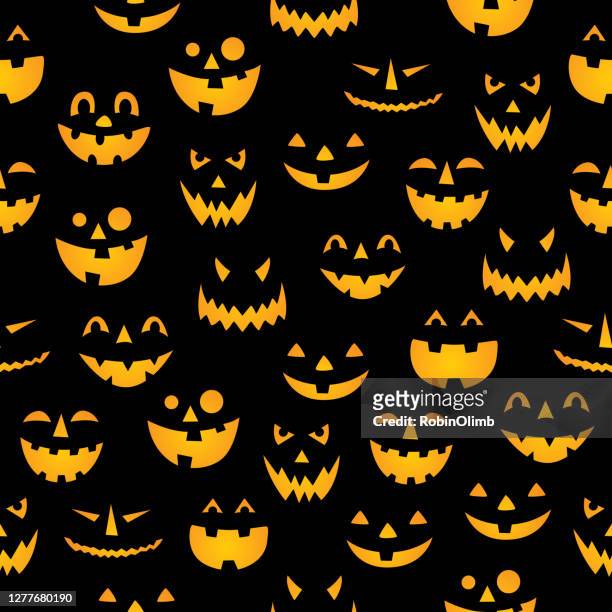 glowing pumpkin faces seamless pattern - halloween stock illustrations