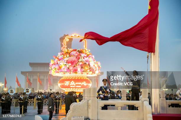 Soldiers of the People's Liberation Army honor guard perform the flag-raising ceremony at Tiananmen Square to mark the 71st Anniversary of the...
