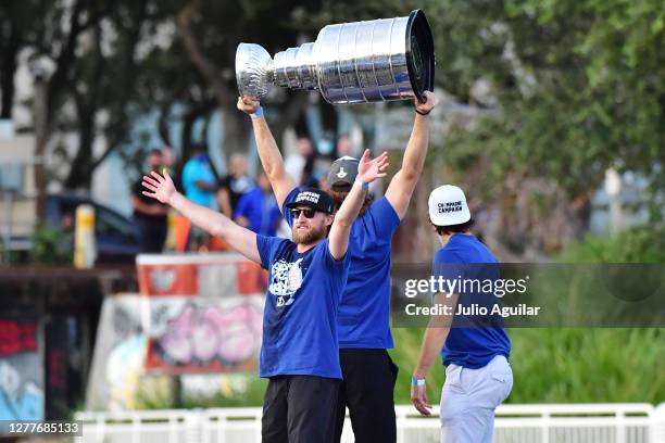 Steven Stamkos celebrates as Victor Hedman hoists the Stanley Cup up next to Luke Schenn of the Tampa Bay Lightning during the Victory Rally & Boat...