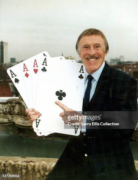 British television presenter Bruce Forsyth holding four giant aces in a promotional shot for the tv series 'Play Your Cards Right', 10th December...