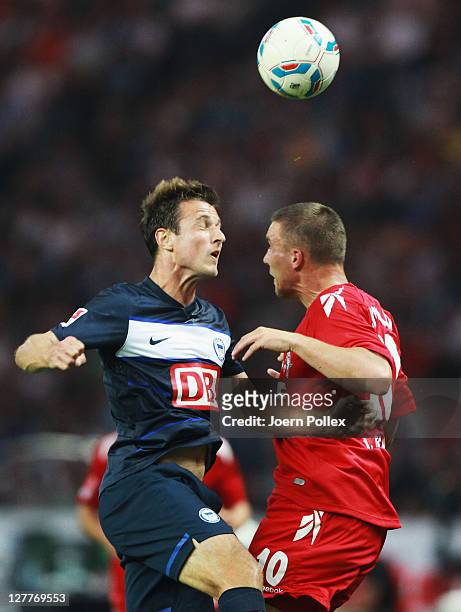 Andre Mijatovic of Berlin and Lukas Podolski of Koeln battle for the ball during the Bundesliga match between Hertha BSC Berlin and 1. FC Koeln at...