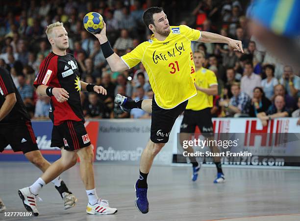 Nicolas Ivakno of Hildesheim throws a goal during the Toyota Handball Bundesliga match between TuS N-Luebbecke and Eintracht Hildesheim on October 1,...