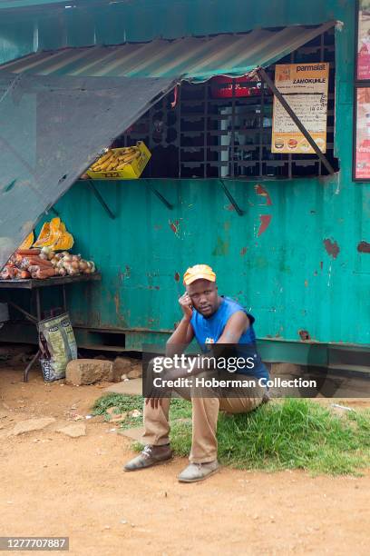 African male 'spaza' shop owner in Soweto township, South Africa