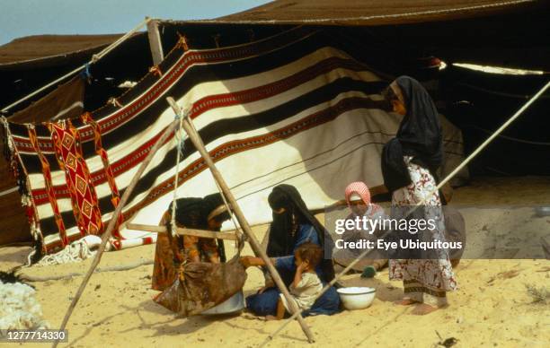 Qatar, General, Bedouin women and children outside tent.