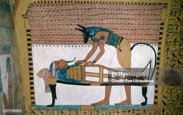 Egypt, Nile Valley, Thebes, Deir al Bahri Temple of Sesedjem. Detail of mural depicting Anubis the jackel headed god of the dead performing a ritual...