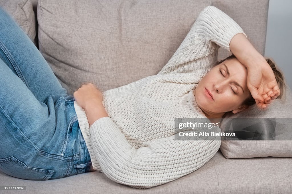 A woman has a stomach ache.